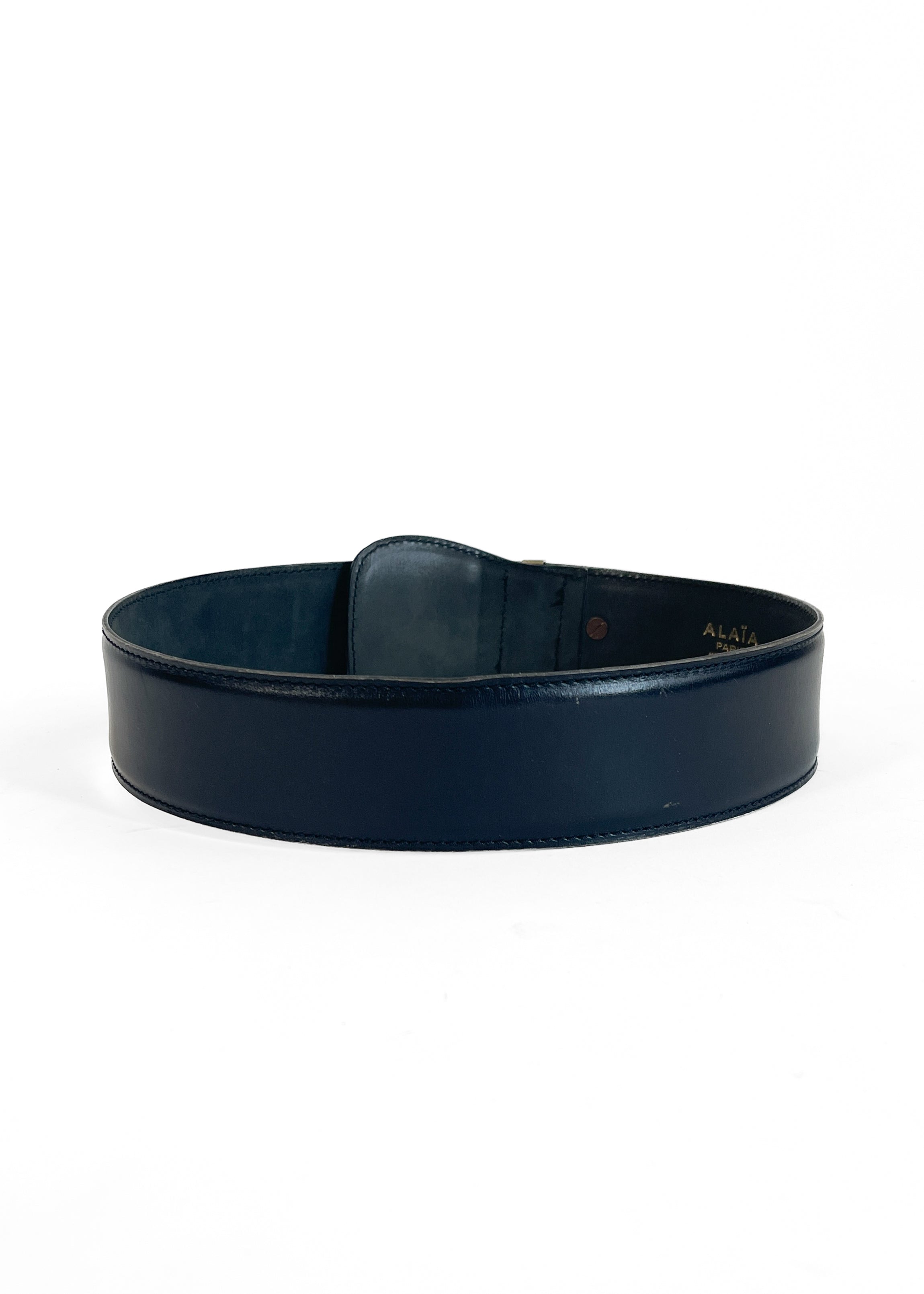 Vintage Alaïa black leather wide belt, back view showing interior construction, white background
