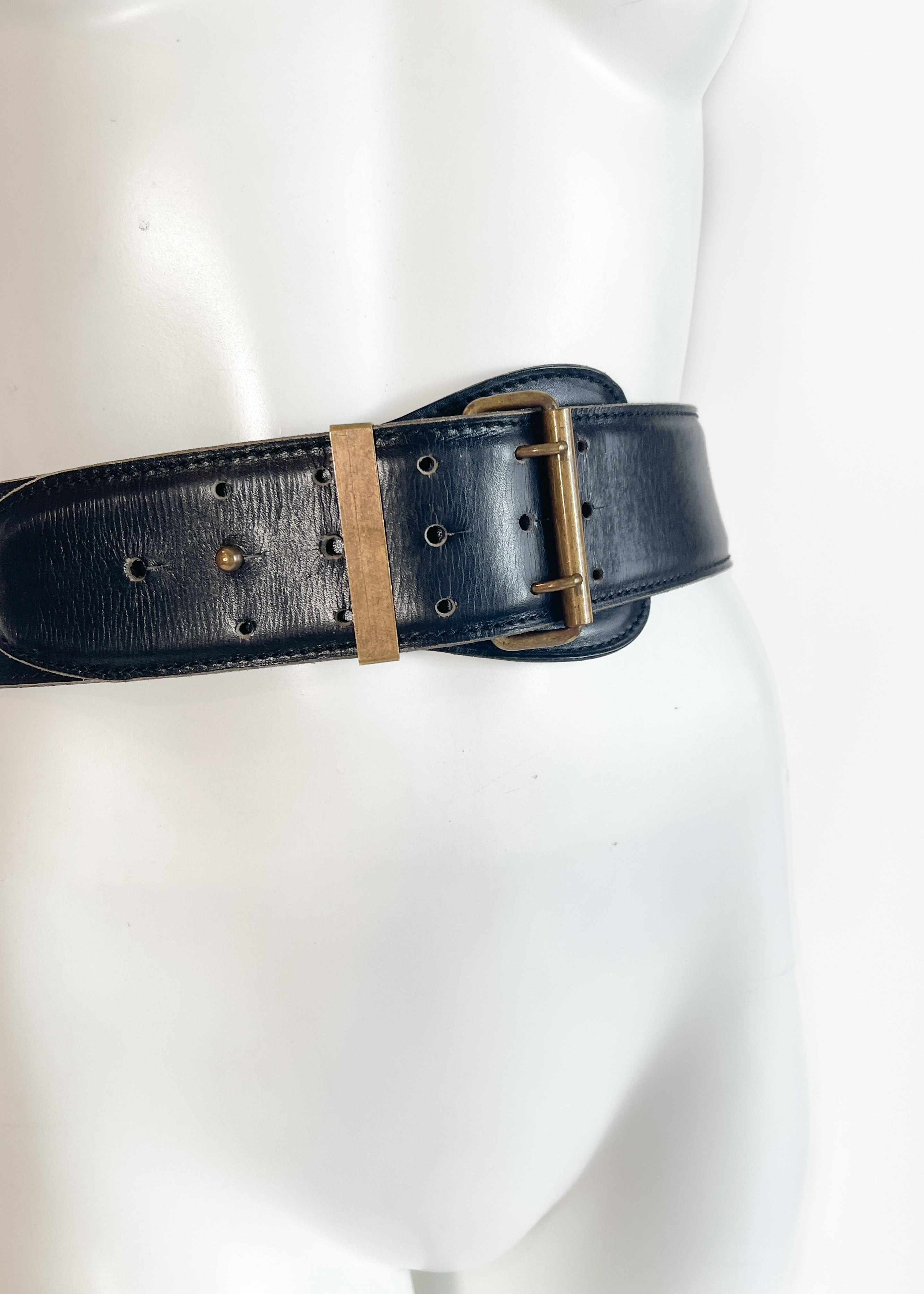 Vintage 1987 Alaïa wide black leather belt on mannequin, three-quarter side angle view